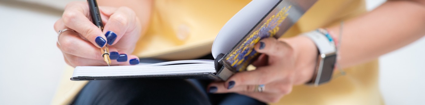 Veronica Țurlea writing in a notebook